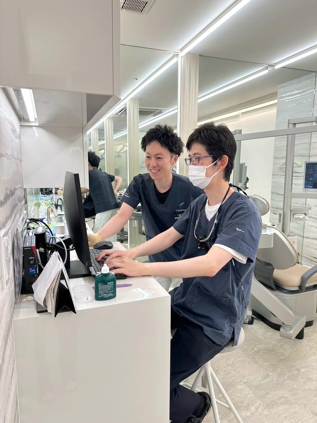 パソコンで情報を確認する歯科医師
